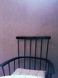 Close-up of empty chair on table against wall at home