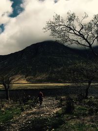 Rear view of man walking on mountain