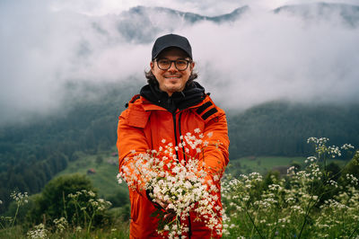 Man standing on field against mountain