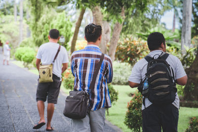 Rear view of people walking outdoors