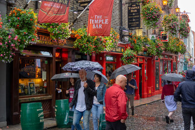 People walking on street in rain