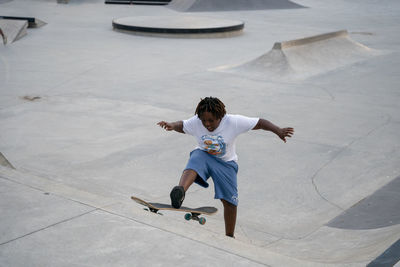 High angle view of boy with arms outstretched