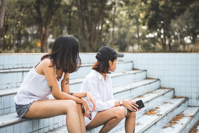 Friends sitting on railing