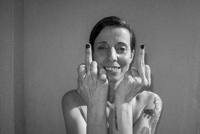 Hipster woman showing middle finger