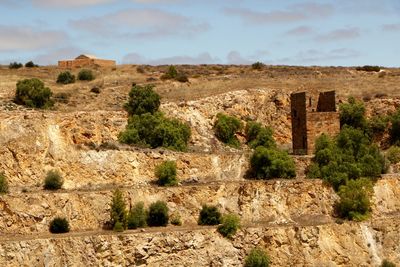 Old ruins on landscape against sky