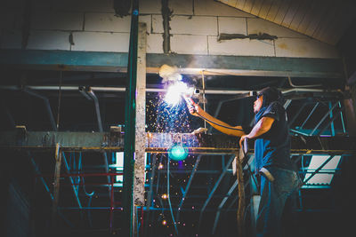 Welder using machine to repair pipes