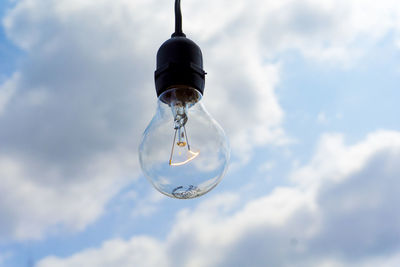 Low angle view of light bulb against sky