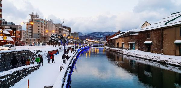 Panoramic view of buildings in city against sky during winter