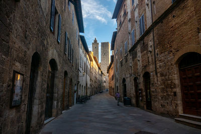 The main street of city of san gimignano in early morning, tuscany