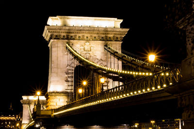Low angle view of suspension bridge at night