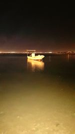 Scenic view of sea against sky at night