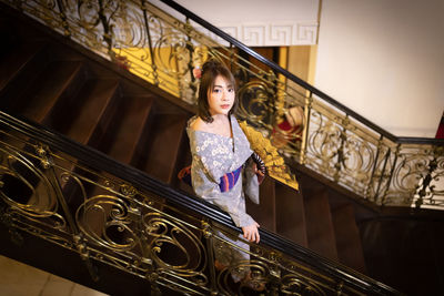 High angle view of young woman on staircase