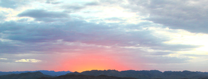 Low angle view of mountains against dramatic sky