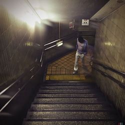Low section of woman walking on stairs