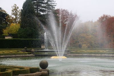 Close-up of fountain in park against sky