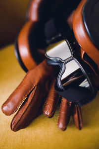 High angle view of sunglasses and leather gloves