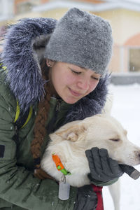 Smiling girl holding dog