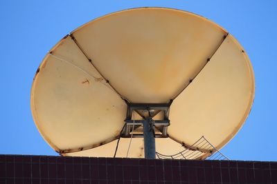 Low angle view of satellite against clear blue sky