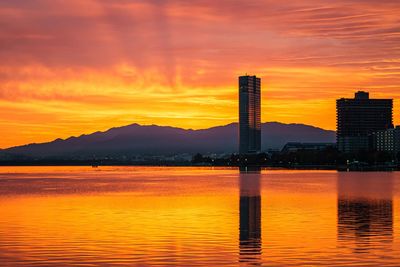 Scenic view of lake against romantic sky at sunset