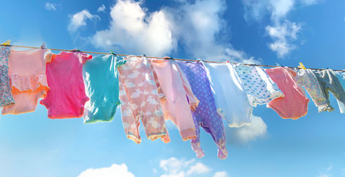 Low angle view of flags against sky