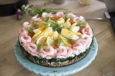 High angle view of cake served in plate on wooden table