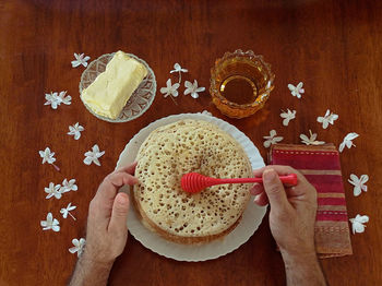 Cropped hand of man holding food on table