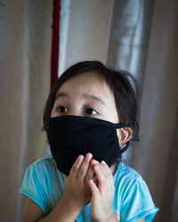 Girl wearing mask at home