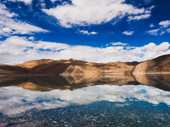 Scenic view of lake against cloudy sky