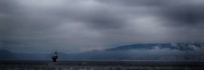 Scenic view of mountains against cloudy sky