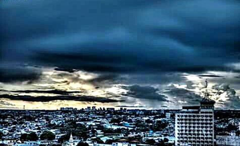 Cityscape against cloudy sky