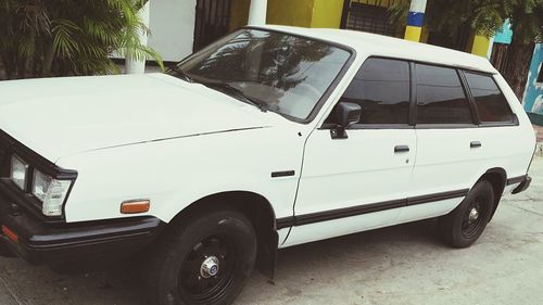 Side view of vehicles parked on road