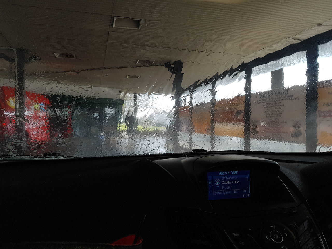 CLOSE-UP OF CAR WINDOW WITH CARS IN BACKGROUND