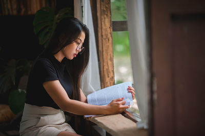 Young woman looking at book