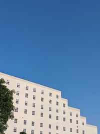 Low angle view of building against clear blue sky