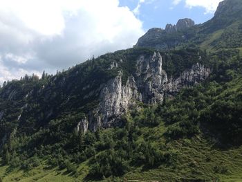 Scenic view of mountains against cloudy sky