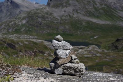 Close-up of statue on rock against sky