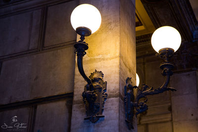 Low angle view of statue against illuminated cathedral