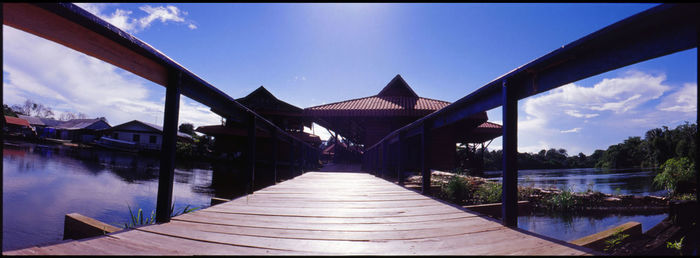 Panoramic view of lake amidst buildings against sky