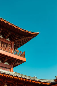 Low angle view of chinese building against clear blue sky