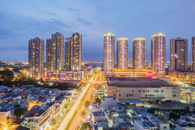 High angle view of illuminated cityscape against sky at dusk