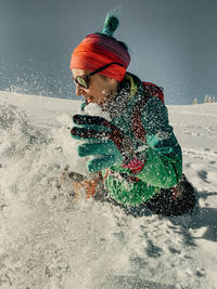 Rear view of girl playing in snow