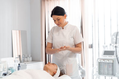 Side view of doctor examining patient at clinic