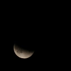 Low angle view of moon in sky at night