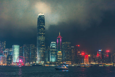 Illuminated buildings in city at waterfront