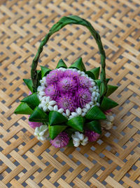 High angle view of purple flower in basket on table