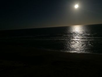 Scenic view of sea against clear sky at night