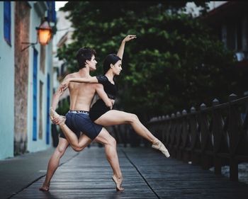 Full length of young couple standing outdoors