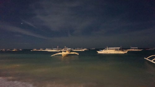 Scenic view of sea against sky at night