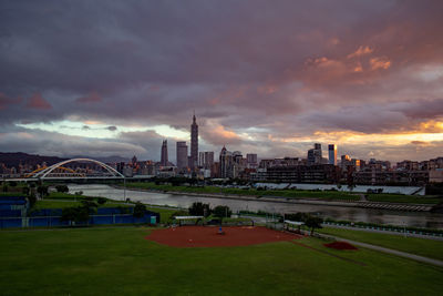View of buildings in city at sunset