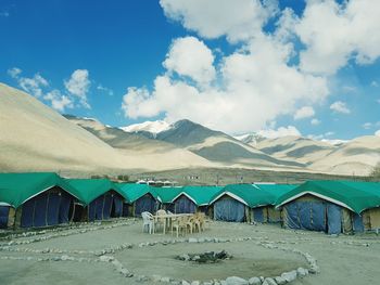 Panoramic view of beach and mountains against blue sky